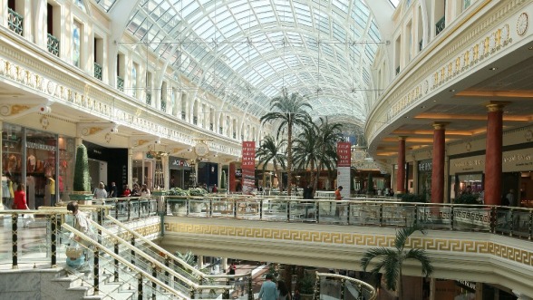 The inside of a bright and busy shopping mall.